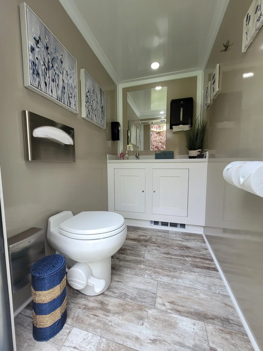 Restroom interior showing the toilet, vanity and floor finish.