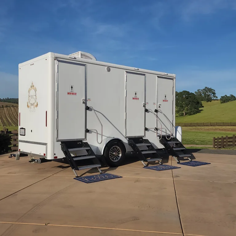Three-station trailer outdoors with individual entry steps.