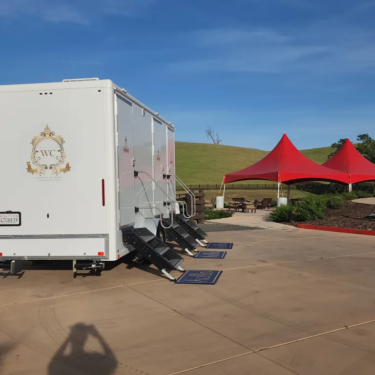 Exterior view of the trailer alongside an outdoor event setup.